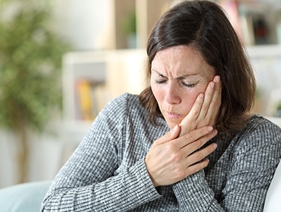 A middle-aged woman suffering a toothache
