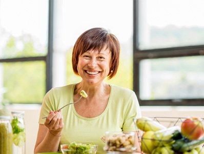 Patient in Annandale eating with dental implants