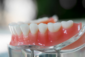 A lower denture sitting on a clear base